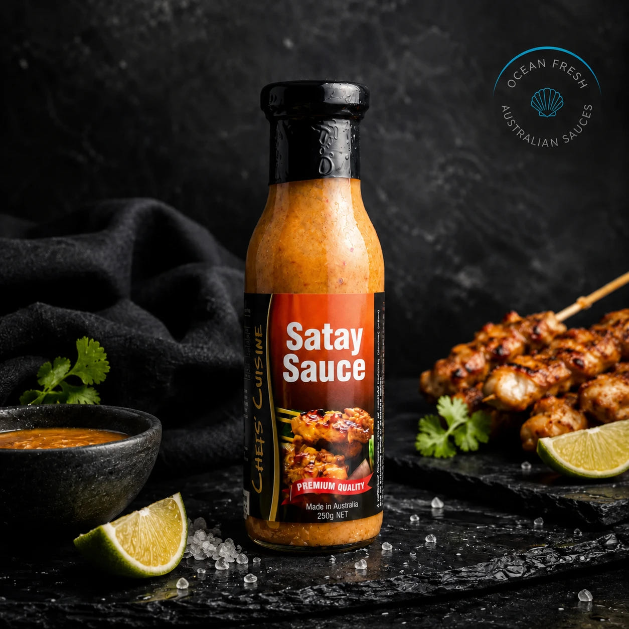 Bottle of Satay Sauce presented on dark stone beside prepared seafood
