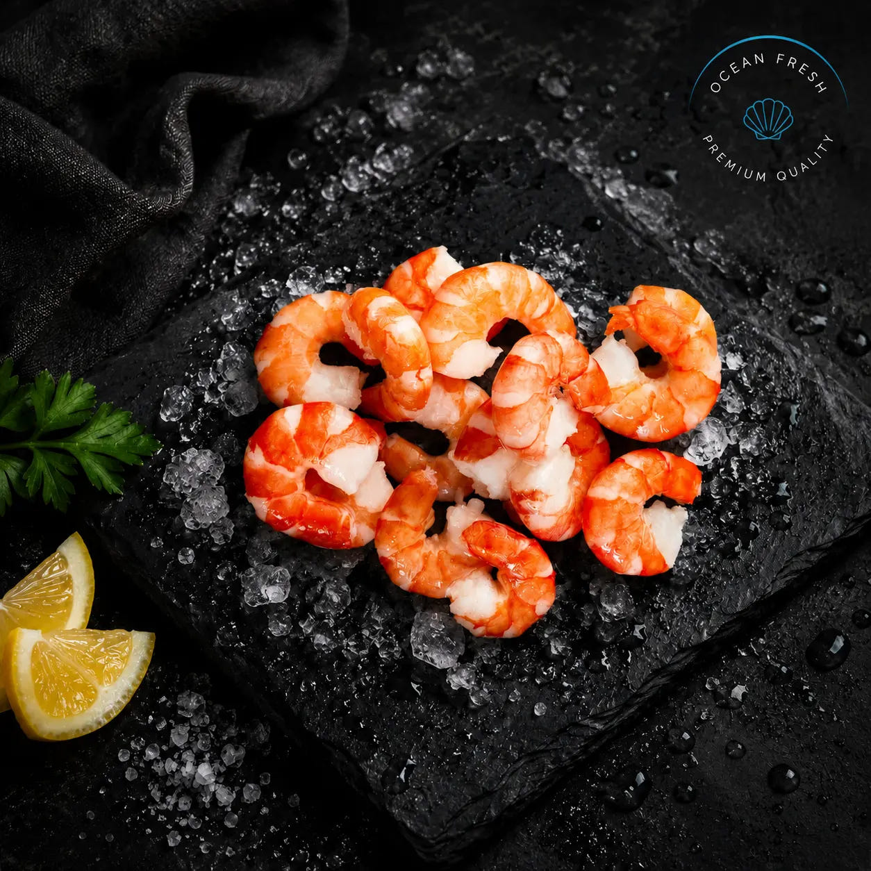 Cooked and peeled prawns piled on crushed ice with lemon wedges and parsley