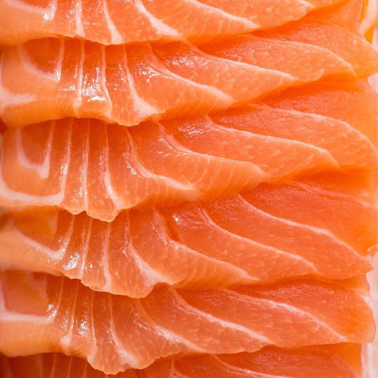 Close-up of a premium salmon fillet showcasing its rich, marbled texture, highlighting the freshness and quality of the seafood.